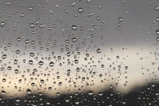 Drops of rain on the window, rainy day. Shallow DOF