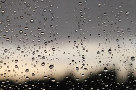 Drops of rain on the window, rainy day. Shallow DOF