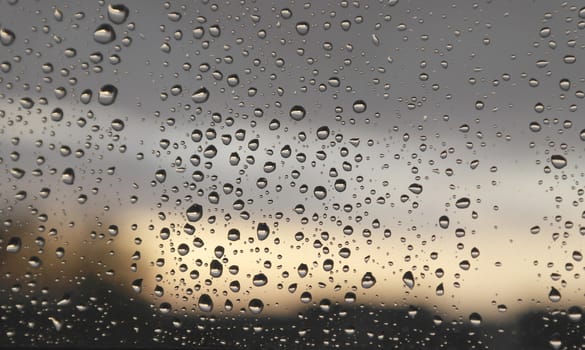 Drops of rain on the window, rainy day. Shallow DOF