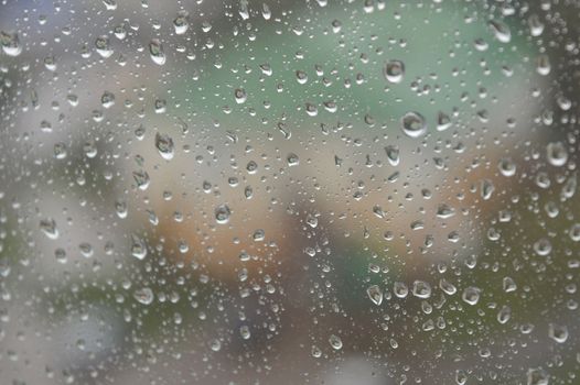 Drops of rain on the window, rainy day. Shallow DOF