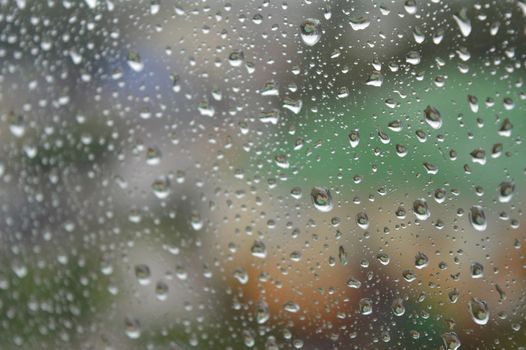 Drops of rain on the window, rainy day. Shallow DOF