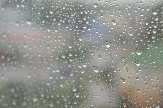 Drops of rain on the window, rainy day. Shallow DOF