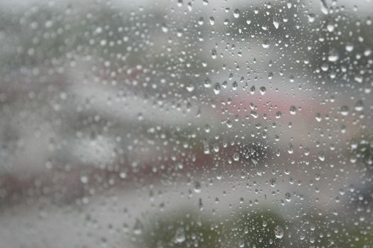 Drops of rain on the window, rainy day. Shallow DOF