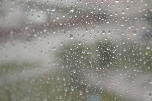 Drops of rain on the window, rainy day. Shallow DOF