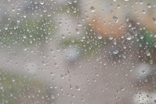 Drops of rain on the window, rainy day. Shallow DOF