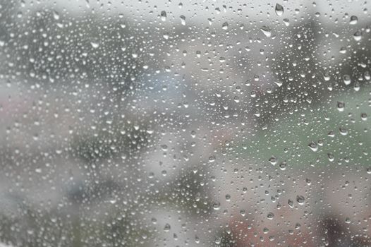 Drops of rain on the window, rainy day. Shallow DOF