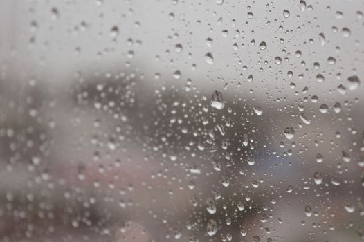 Drops of rain on the window, rainy day. Shallow DOF