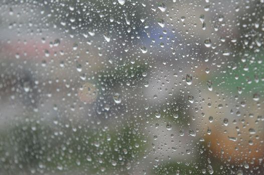 Drops of rain on the window, rainy day. Shallow DOF