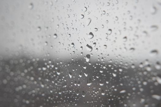 Drops of rain on the window, rainy day. Shallow DOF