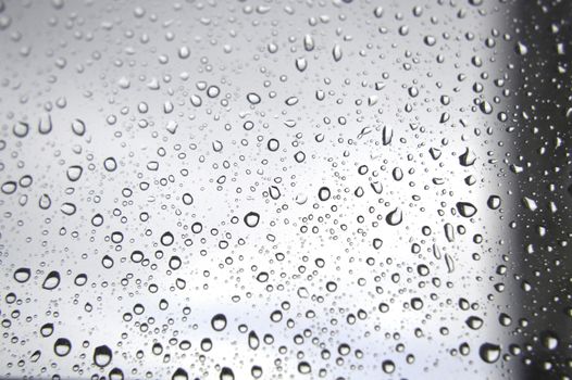 Drops of rain on the window, rainy day. Shallow DOF