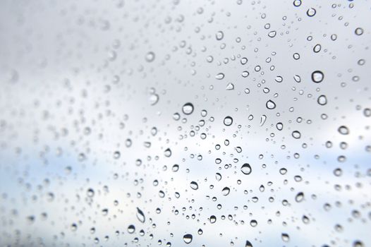 Drops of rain on the window, rainy day. Shallow DOF