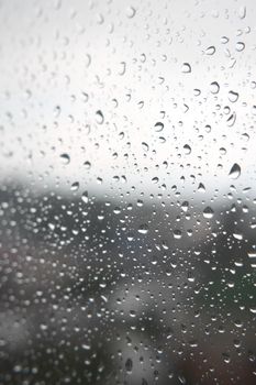 Drops of rain on the window, rainy day. Shallow DOF