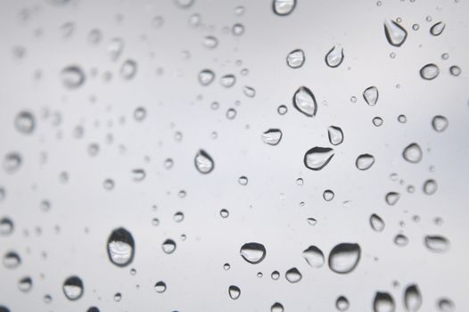 Drops of rain on the window, rainy day. Shallow DOF