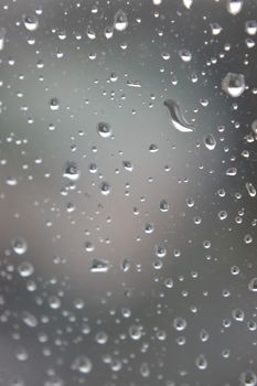 Drops of rain on the window, rainy day. Shallow DOF