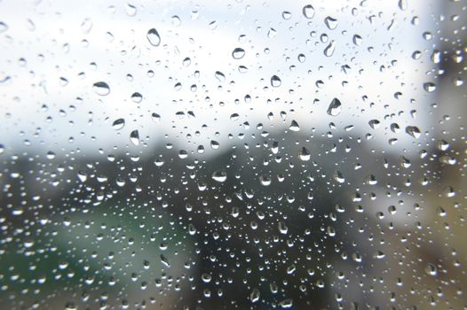 Drops of rain on the window, rainy day. Shallow DOF