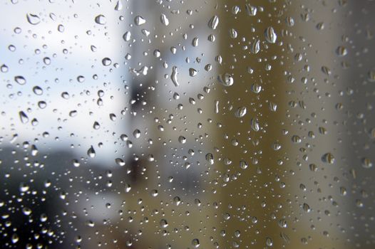 Drops of rain on the window, rainy day. Shallow DOF