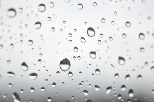 Drops of rain on the window, rainy day. Shallow DOF