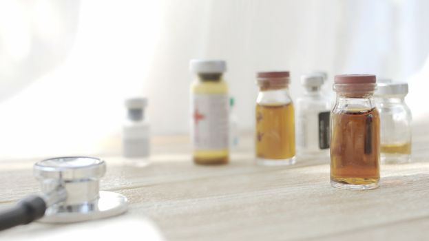 Vaccine bottles placed on the doctor's desk. At the lab in the hospital