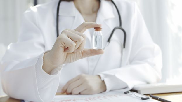 doctor's hand has a vaccine bottle Medicine concept