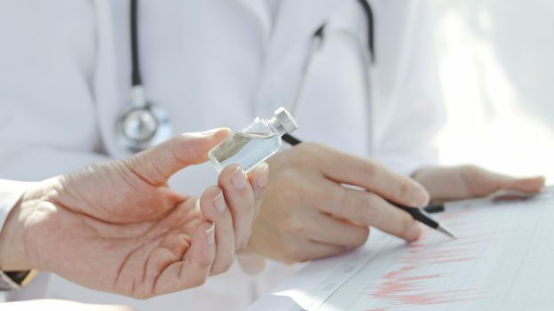 doctor's hand has a vaccine bottle Medicine concept