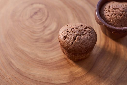 Homemade chocolate cupcakes on a wooden table. High quality photo