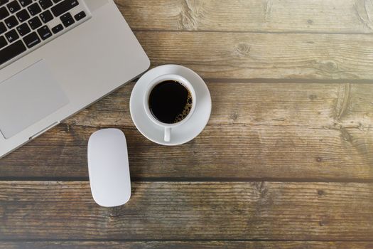 Top view Laptop, mouse, coffee on wood table. Laptop, mouse, espresso coffee on table with copy space banner. Business concept.