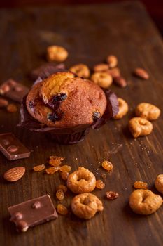 Chocolate maffin on a wooden table with chocolate and tartallini . High quality photo