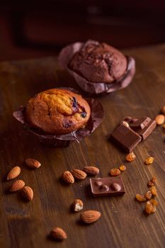 Chocolate maffin on a wooden table with chocolate and tartallini . High quality photo