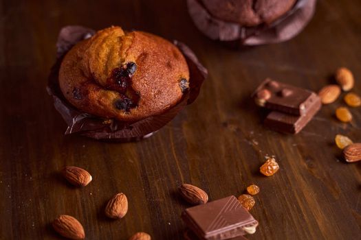 Chocolate maffin on a wooden table with chocolate and tartallini . High quality photo