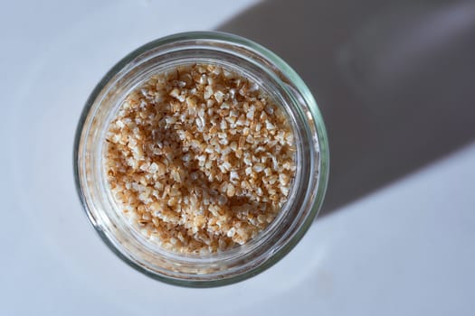 Corn grits in a glass jar. High quality photo