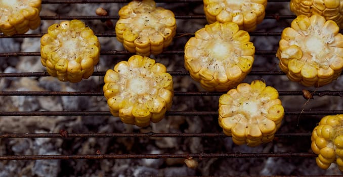 Yellow corn lies on the grill. Top view. With copy space. High quality photo