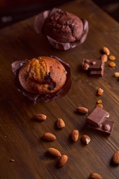 Chocolate maffin on a wooden table with chocolate and tartallini . High quality photo