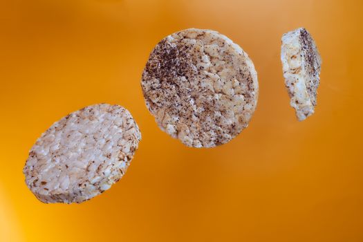 Wheat breads fall on orange background. High quality photo