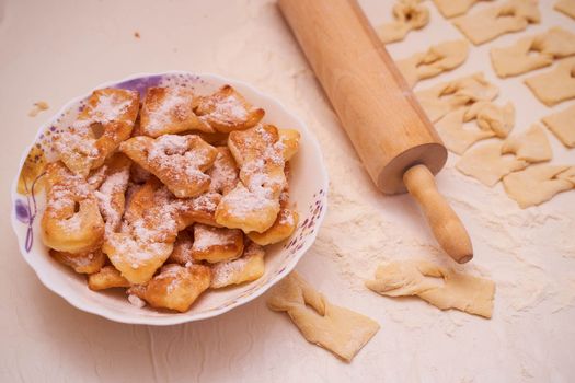 Homemade pastry, sprinkled with powdered sugar on a light table. High quality photo