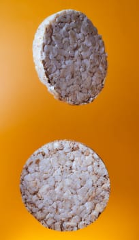 Wheat breads fall on orange background. High quality photo