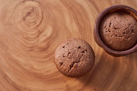 Homemade chocolate cupcakes on a wooden table. High quality photo