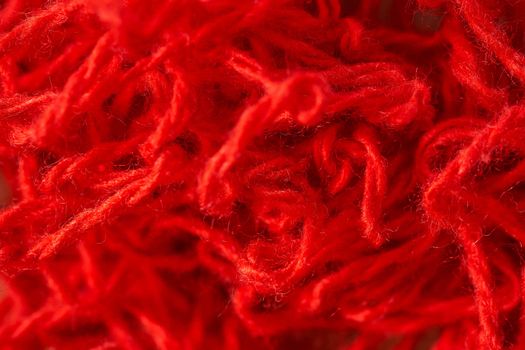 Background of red synthetic yarn. Close-up. Macro effect photo. High quality photo