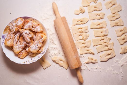 Homemade pastry, sprinkled with powdered sugar on a light table. High quality photo