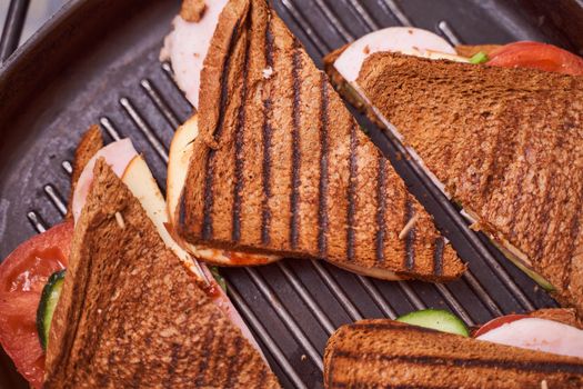 Homemade sandwiches lie on the groa grill. High quality photo