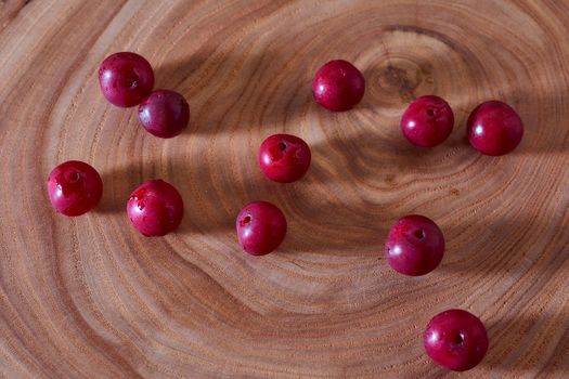 Ripe cherry berry on a wooden slice of wood. High quality photo