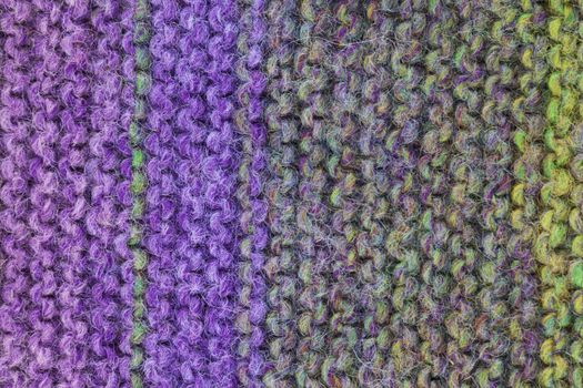A knitted wool texture background purple and green
