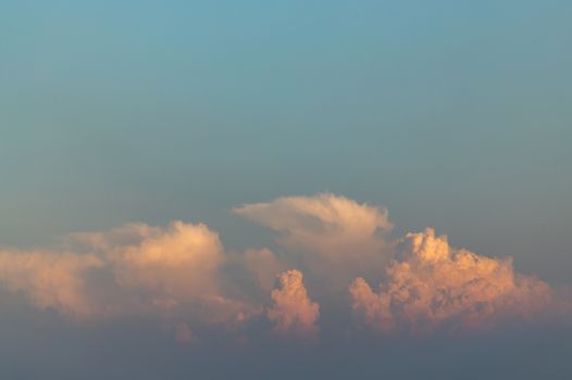Beautiful orange clouds with dramatic light and blue sky. Beautiful blazing sunset landscape, Warm Colours,  Inspirational concept with copy space.