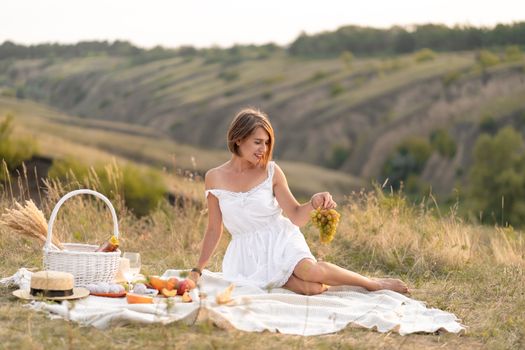 A romantic date with a beautiful girl. An evening picnic in a picturesque, uninhabited place
