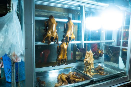 Smoked duck glass box. Food street seller in Bangkok