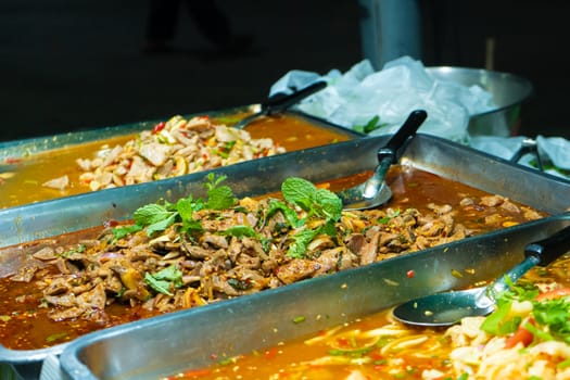 Asian street food night market. Mobile food counter carts