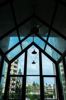 Glass construction in the shape of a house, a stylish lobby in a modern condominium