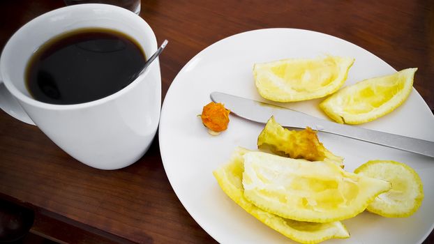 Finish eating fruits and starting drinking black coffee. Food and Drink.