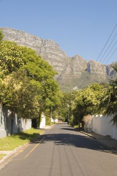 Street in the town of Claremont, Cape Town, South Africa. Sunny weather and panorama of Table Mountains.