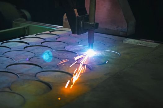 Cutting the welding parts out of the sheet of steel. Manufacturing plant