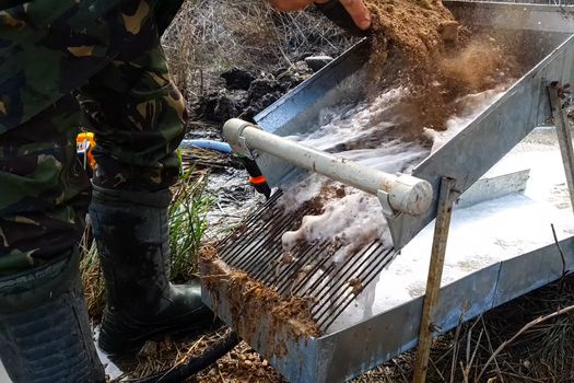 Washing the rock containing gold. Search and extraction of gold.